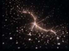 Visual reference — a dense field of golden particles scattering through dark space.
